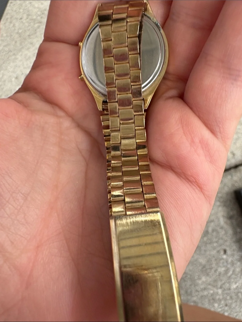 retro digital display and linked metal band typical of 1980s timepieces.